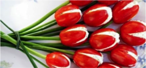 Cherry tomatoes stuffed with cottage cheese make for a whimsical Mother's Day appetizer! Use chives for stems!